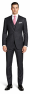 Mantoni charcoal wool suit by Albertonardoni. Fitted, single-breasted, two-button design. Charcoal gray wool. Slim-fit trousers. Two front pockets, breast pocket. Smooth texture. Styled with a light shirt and pink tie.
