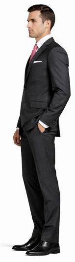 Mantoni charcoal wool suit: Tailored two-button jacket with standard lapels. Charcoal gray wool, smooth texture. Includes matching slim-fit trousers. White shirt and pink tie accent.
