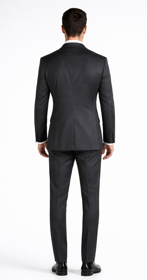 Dark grey Mantoni double-breasted suit crafted from wool. Structured silhouette with peak lapels, two-button closure, and fitted trousers. Clean, tailored fit; straight leg pants and black shoes complete the look.
