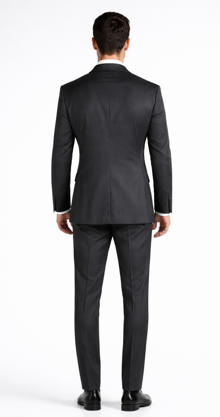 Dark grey Mantoni double-breasted suit crafted from wool. Structured silhouette with peak lapels, two-button closure, and fitted trousers. Clean, tailored fit; straight leg pants and black shoes complete the look.
