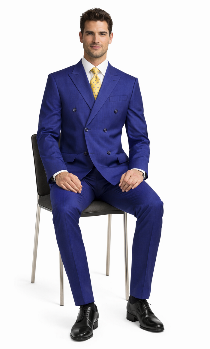Vibrant blue double-breasted wool suit. Structured silhouette with notched lapels, two rows of buttons, and front pockets. Tapered trousers. Tailored fit.
