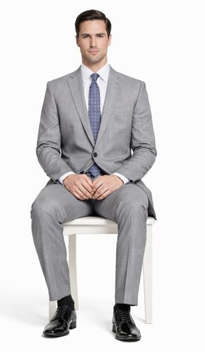 Mantoni light gray wool suit: two-button jacket with notch lapels, modern/slim fit. Flat-front trousers. Smooth texture, consistent light gray. Jacket: two pockets, single vent. Trousers: straight-cut, regular waist.

