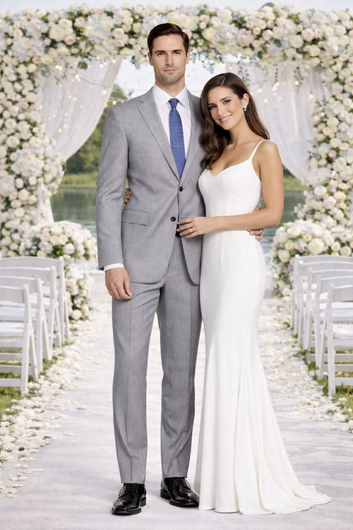 Mantoni light gray wool suit with a modern slim fit. Features a textured wool fabric, notched lapel, and a single back vent. Includes a blue tie. Tailored slim-fit trousers with a crease. Formal appearance.
