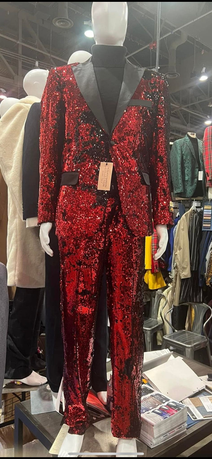 Men's red sequin tuxedo suit. Slim fit blazer with black lapel, single-button closure, and side pockets. Matching pants. Luxury and stylish.
