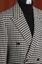 Men's modern fit houndstooth blazer in black/white, 100% wool. Features a distinctive houndstooth pattern and a structured, double-breasted design.