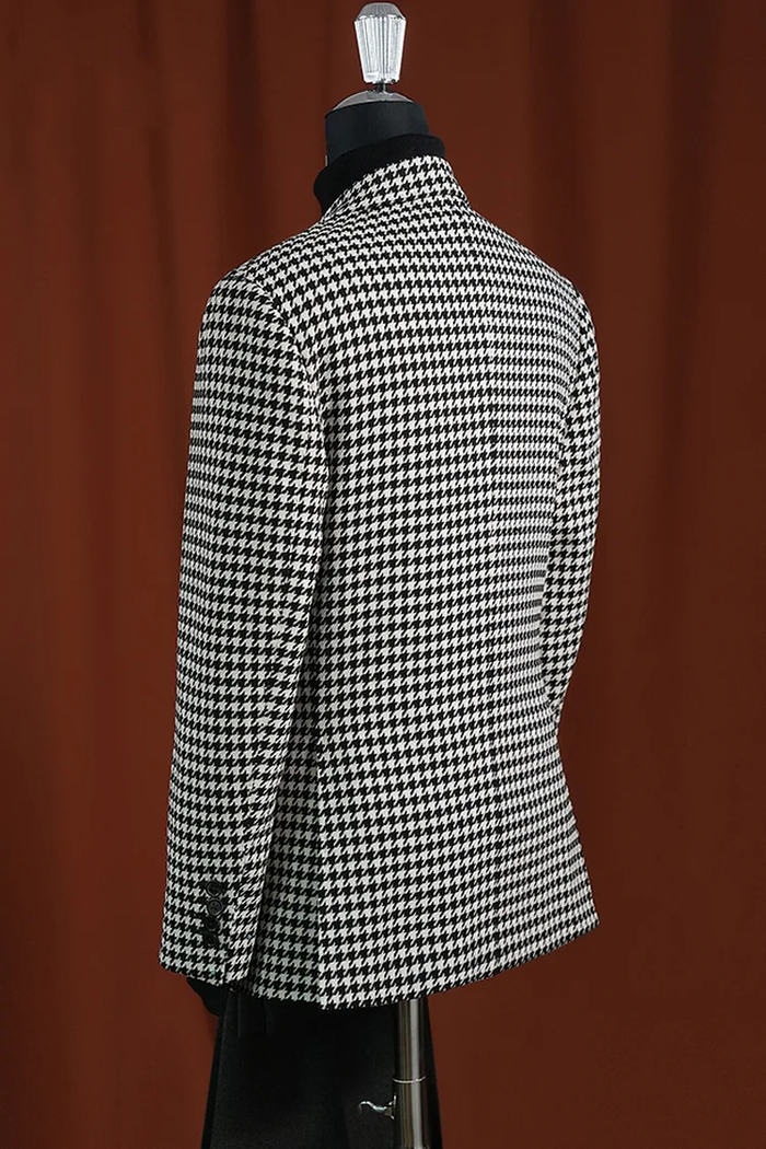 Men's modern fit houndstooth blazer in black & white wool. Structured silhouette, notch lapel, and tailored fit. Classic houndstooth pattern. Hip length, button cuffs, and clean back.
