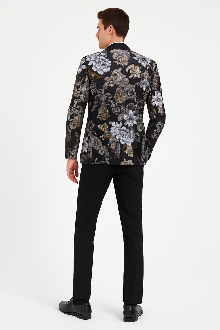 Men's black blazer with gold & silver floral jacquard. Satin shawl lapel. Paired with black pants. Elegant, detailed design.
