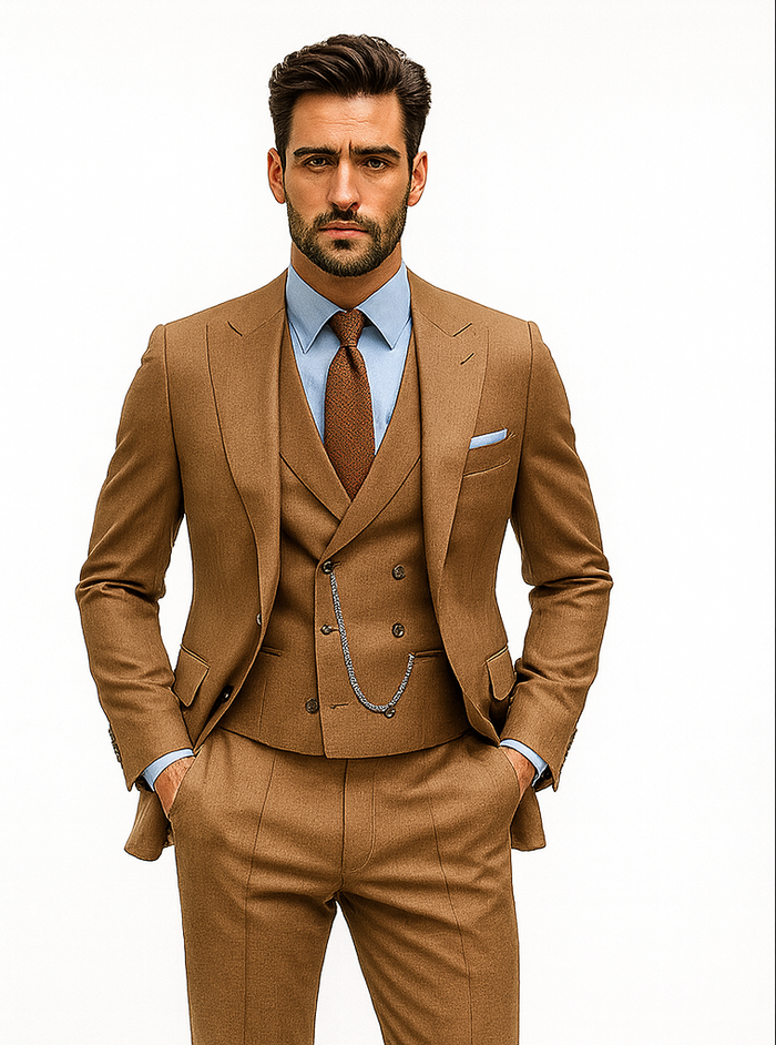 Camel brown suit: tailored blazer, double-breasted vest, matching trousers. Light blue shirt. Peak lapels, chain accessory. Formal, contrasting colors.
