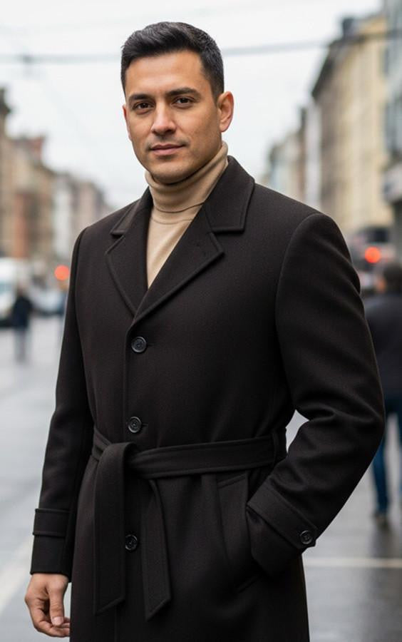 Men's brown double-breasted overcoat. Knee-length, heavyweight fabric, wide collar, and belted waist. Tailored silhouette with large buttons. Solid dark brown color.

