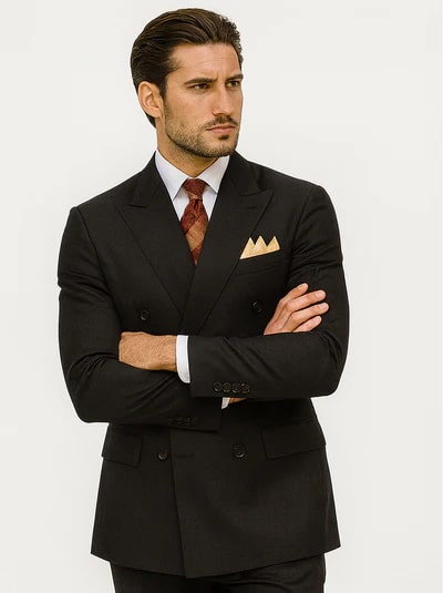 Men's black double-breasted poplin suit. Classic structured silhouette with sharp lapels, long sleeves, and a fitted design. Features side pockets. Paired with white shirt and red patterned tie. Formal.
