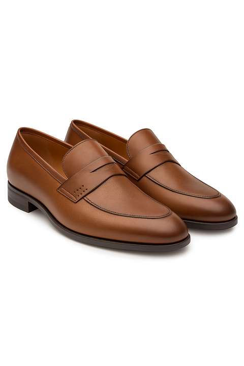 Mezlan Fabrizi penny loafers in cognac calfskin. Smooth texture, classic penny slot, and slightly pointed toe. Rich brown color with subtle shine and perforated side detailing for a sophisticated look.

