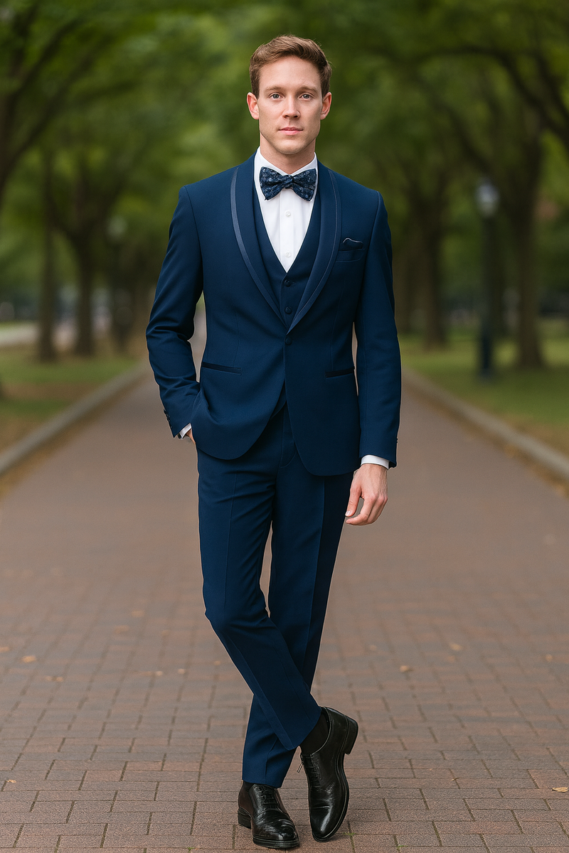 Navy blue men's tuxedo with satin shawl lapel. Includes fitted jacket, waistcoat, and tailored trousers. Features blue trim and a matching bow tie.
