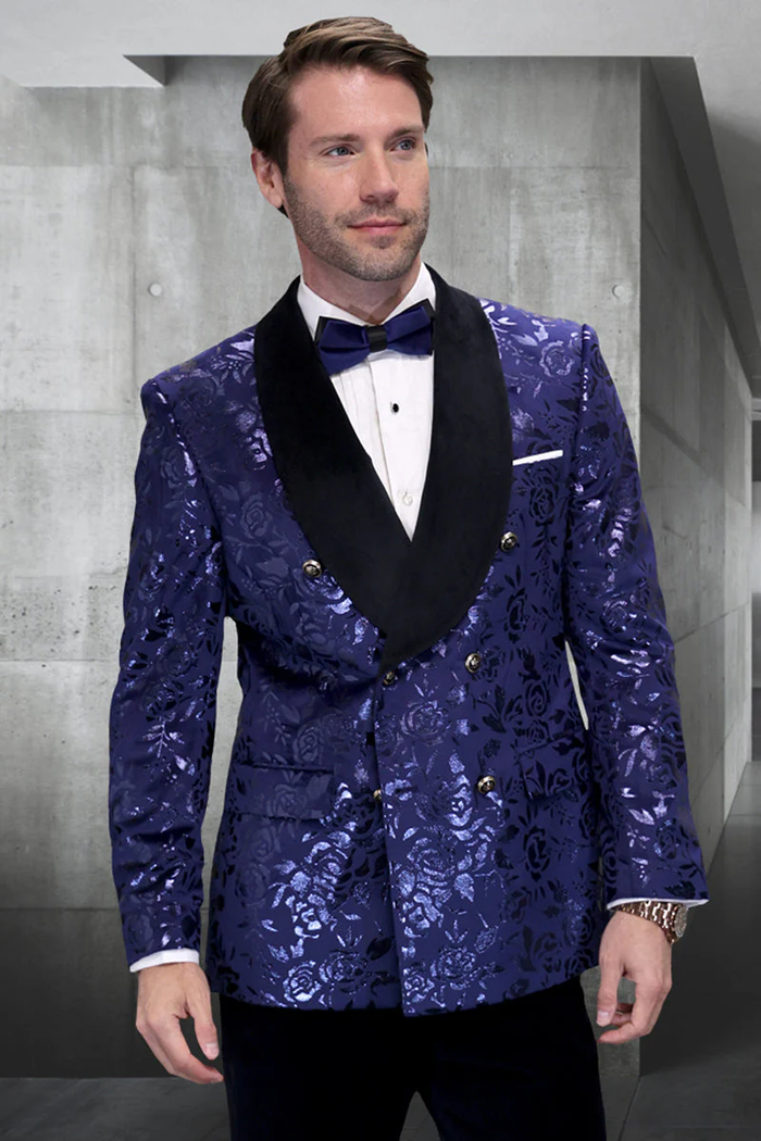 Navy floral jacquard tuxedo jacket. Double-breasted, black shawl lapel, gold buttons. Floral pattern in blues. White cuff accents.
