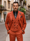 Luxury red men's suit: modern tailored fit, single-breasted jacket, double-breasted vest. Woven, textured fabric. Black shirt, patterned tie. Tailored lapels, decorative chain. Vibrant red with dark vest buttons.
