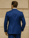 Luxury blue three-piece suit: fitted jacket with smooth texture, structured shoulders, sleek back, and matching trousers.
