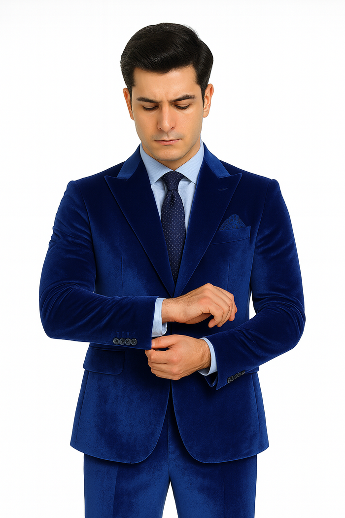 Royal blue velvet suit for men. Slim fit, tailored blazer with peak lapels, single-breasted. Matching close-fitting trousers. Luxurious, lustrous texture.
