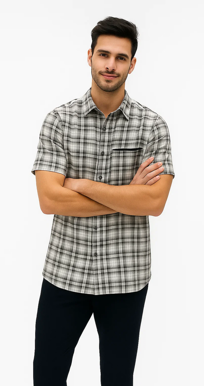 Men's black & white textured plaid walking suit. Short-sleeved, button-up shirt with chest pocket. Checkered pattern. Dark pants complete the set. Distinct textured look.
