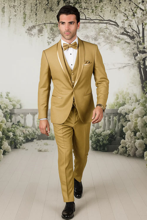 Gold champagne tuxedo. Satin shawl collar, three-piece vest. Fitted silhouette, tailored trousers. Includes matching bow tie and pocket square. Formal elegance.
