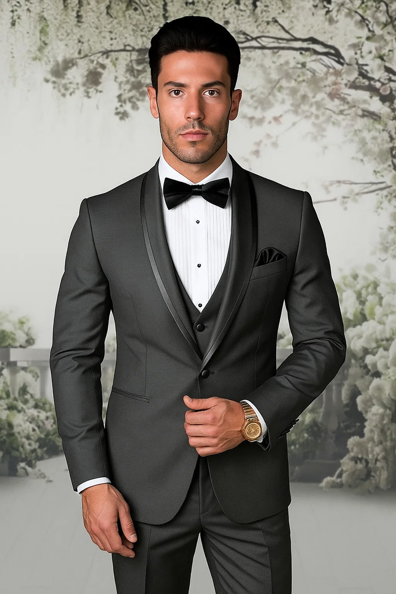 Men's charcoal satin shawl tuxedo: fitted silhouette, shawl collar, single-button closure, three-piece with vest. Smooth, shiny fabric. Includes white pleated shirt, black bow tie, pocket square, tailored trousers.
