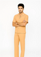 Melon-colored leisure suit: short-sleeved button-up shirt with collar, chest pocket, and visible seams/buttons. Matching straight-cut, loose-fit pants. Lightweight, slightly sheen fabric.
