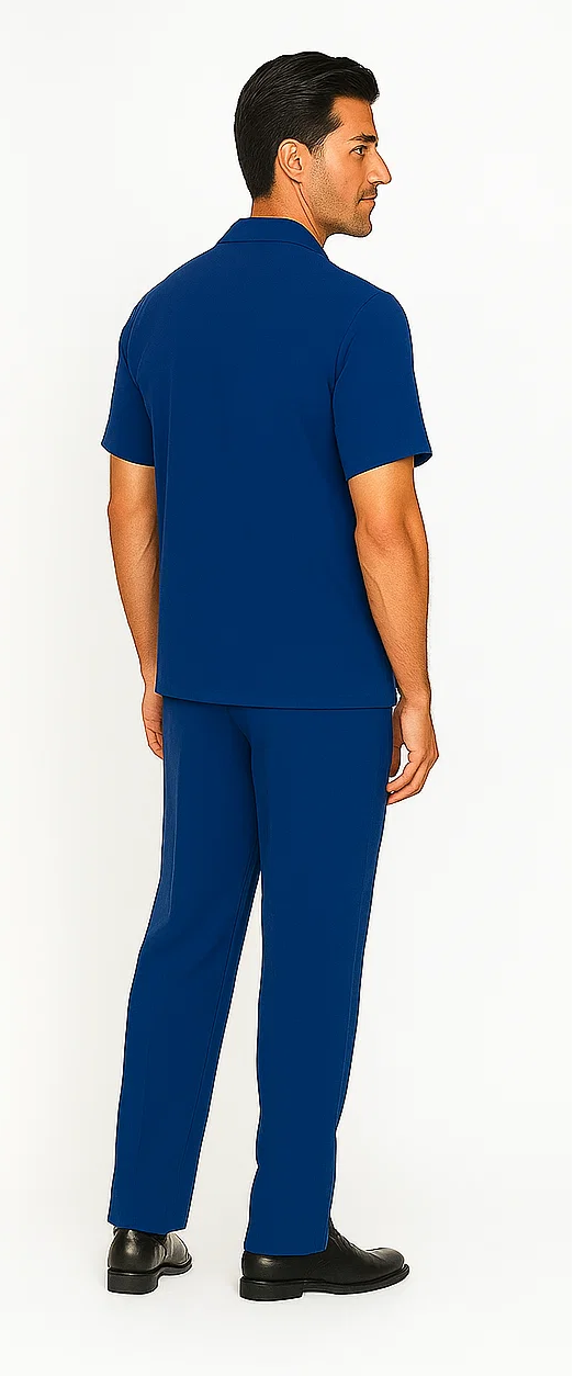Royal blue men's leisure suit: short-sleeve collared shirt and matching pants. Smooth, casual fabric, fitted silhouette. Perfect for relaxed occasions.
