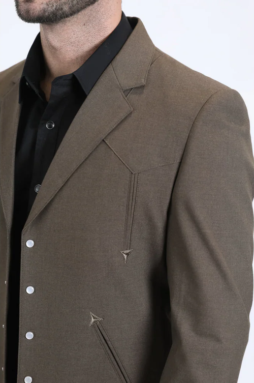 Brown men's western sport suit. Tailored fit, structured silhouette. Smooth textile with contrasting light stitching & metal buttons. Angular seams and lapels enhance the design. Jacket features decorative elements.
