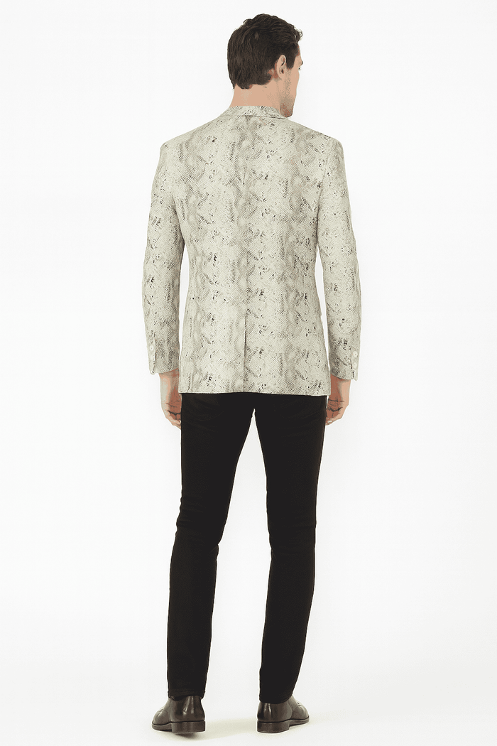 Men's slim-fit white snake print blazer. Structured shape with textured muted white & gray snakeskin pattern. Decorative sleeve buttons. Contoured figure fit.

