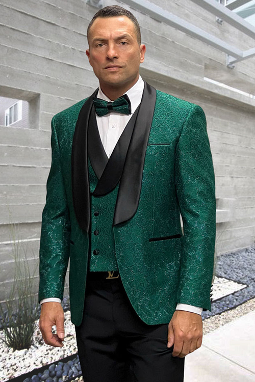 Hunter green designer tuxedo for men. Fitted jacket with floral lace, satin lapels. Matching vest. Black trousers complete the elegant ensemble.
