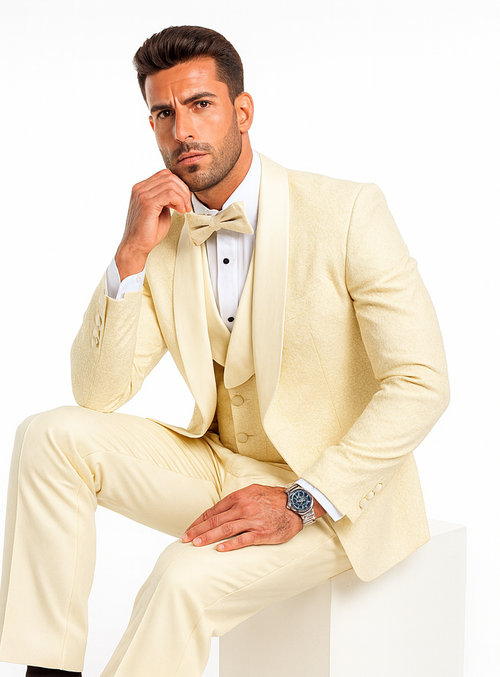 Ivory designer tuxedo for men. Fitted silhouette with shawl lapel, vest, and trousers. Elegant floral lace pattern in light cream.

