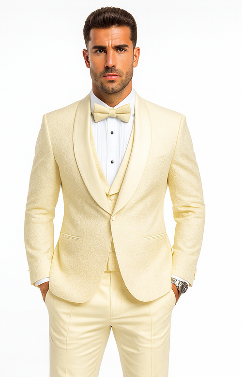 Ivory tuxedo with textured fabric, shawl collar jacket, and matching trousers. Includes a pleated formal shirt and coordinating bow tie. A sophisticated, fitted ensemble for formal events.
