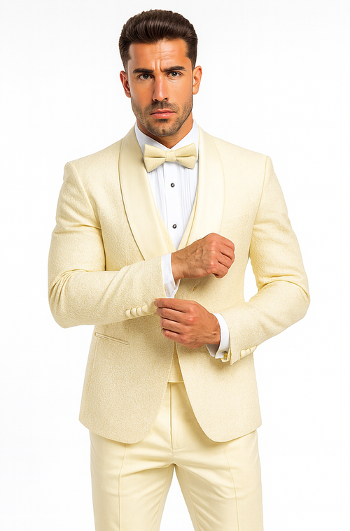 Ivory men's designer tuxedo. Elegant vest, floral lace. Tailored jacket, bow tie, fitted trousers. Light ivory color. A stylish and sophisticated formal look.
