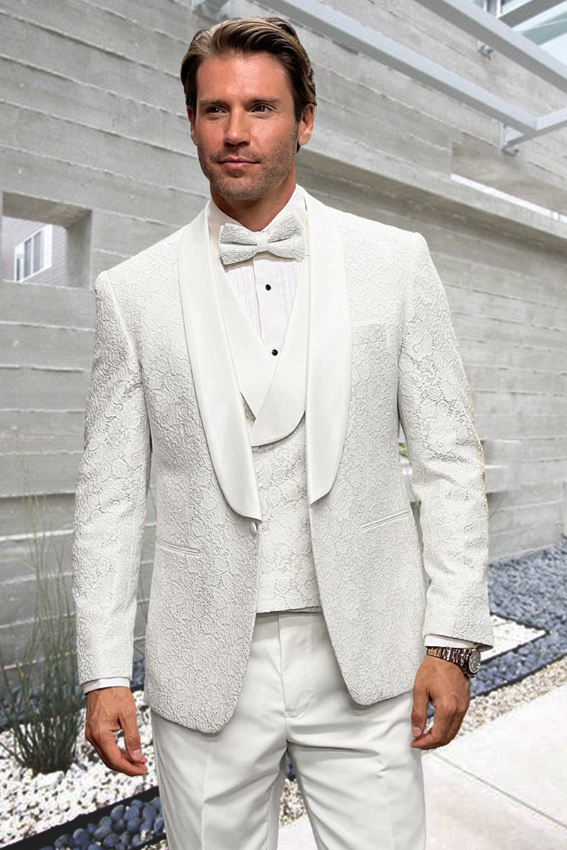 White designer tuxedo: fitted, floral lace pattern. Includes double-breasted vest, textured jacket & matching pants. Stylish formalwear for men.
