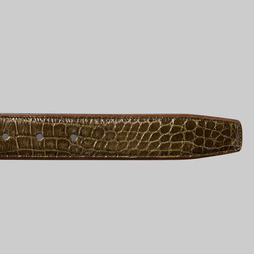 Olive green alligator belt by Mezlan. Narrow, tapered design with a glossy finish. Features the distinctive texture of alligator skin and adjustable holes.

