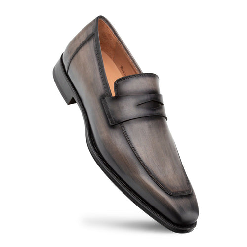 Dark grey Mezlan Avenue penny loafers. Streamlined, elongated silhouette with a rounded toe. Crafted from leather with subtle sheen. Features penny strap & slightly raised rubber sole for a polished look.
