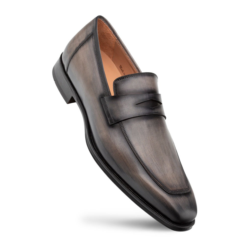 Dark grey Mezlan Avenue penny loafers. Streamlined, elongated silhouette with a rounded toe. Crafted from leather with subtle sheen. Features penny strap & slightly raised rubber sole for a polished look.
