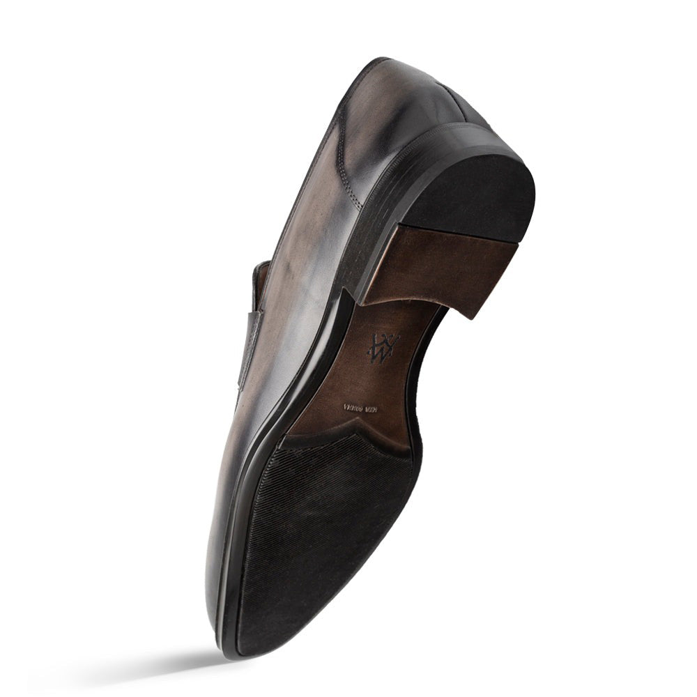 Mezlan Avenue penny loafers: Dark grey smooth leather upper, rubber sole. Sleek, streamlined design with low heel and textured sole for grip. No visible fastenings.
