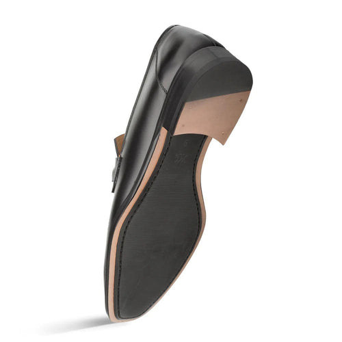 Black Mezlan leather loafers with smooth finish, decorative ornament, and structured heel. Contrast rubber/leather sole. Rounded toe, side goring for flexibility.
