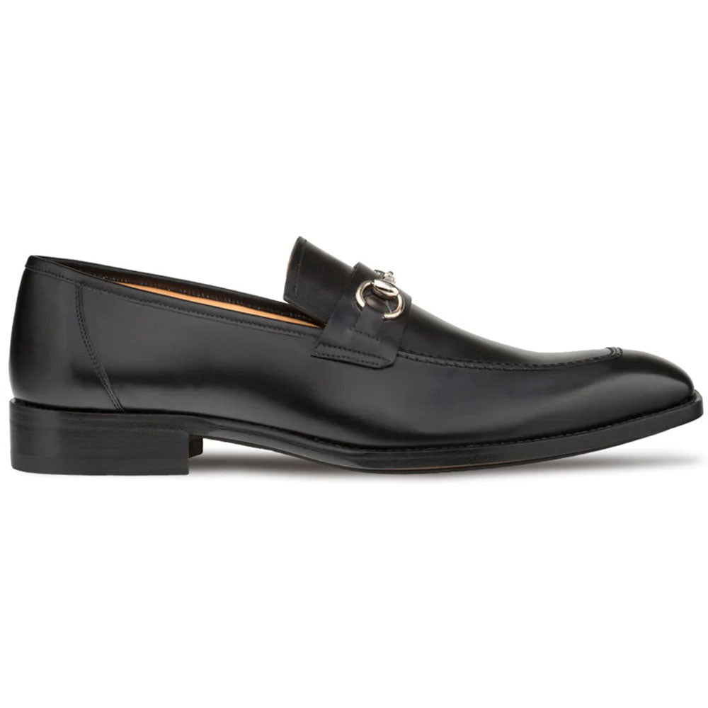 Black Mezlan loafers. Smooth leather with a rounded toe and metal ornament. Minimalist design, clear stitching, and slightly elevated heel.
