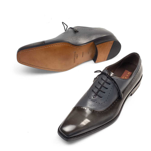 Mezlan Potsdam oxford: Grey calfskin dress shoe with a cap toe and pointed silhouette. Features textured leather accents, perforated design, and a brown leather outsole.
