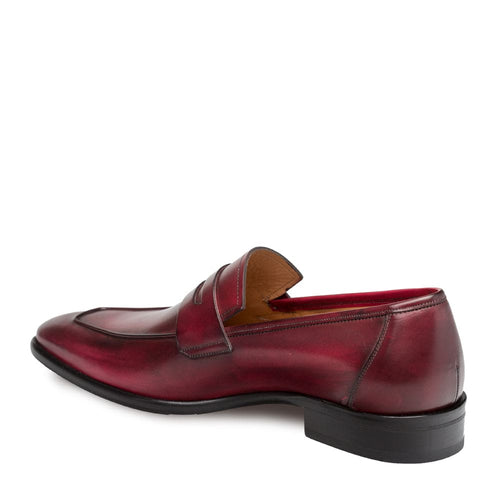 Mezlan burgundy calfskin penny loafers. Sleek slip-on design with a raised penny slot. Crafted from smooth leather, rounded toe, and low black heel. Structured silhouette.

