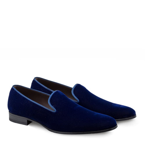 Navy velvet Mezlan Lublin tuxedo loafers. Slip-on, rounded shape, slightly elevated heel. Navy blue velvet with subtle sheen. Blue piping trim. Solid construction, no patterns or embellishments.
