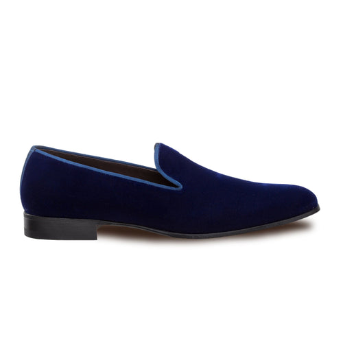 Mezlan Lublin navy velvet tuxedo loafers: sleek, elongated slip-ons. Soft navy velvet upper with blue piping. Low black heel. Classic, easy-wear design.
