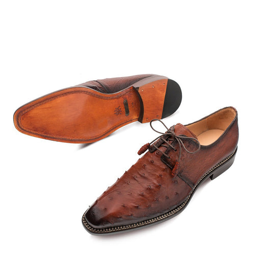 Mezlan Tillson Blucher in Brandy: Brown ostrich leather with pointed toe & lace-up design. Features textured upper & dark toe cap. Leather outsole with rubber heel.
