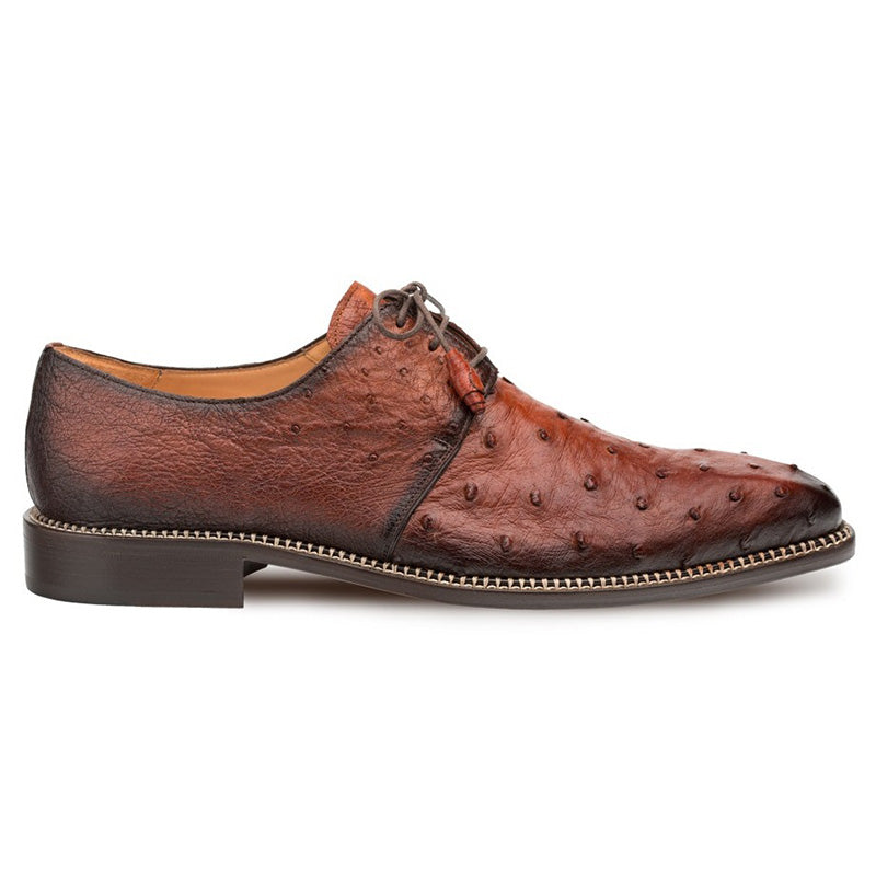 Mezlan Tillson Ostrich Blucher in brandy, sleek elongated shape. Dark brown textured ostrich leather, plain toe. Contrasting stitch, lace-up closure. Brown leather sole, refined finish.
