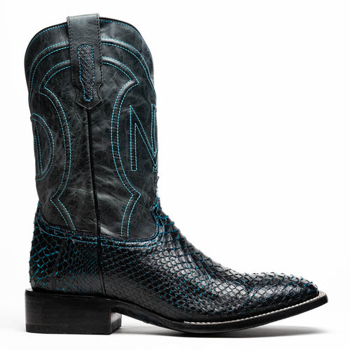 Marco Di Milano Missouri cowboy boots: black python vamp, blue-stitched black shaft, square toe, ornate ankle design, stacked heel. Offers structured design & stability.
