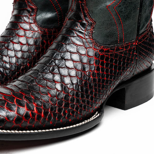 Black python cowboy boots by Marco Di Milano. Featuring textured black leather, red stitching, square toe, and dark green ankle panels. Completed with a sturdy black heel.
