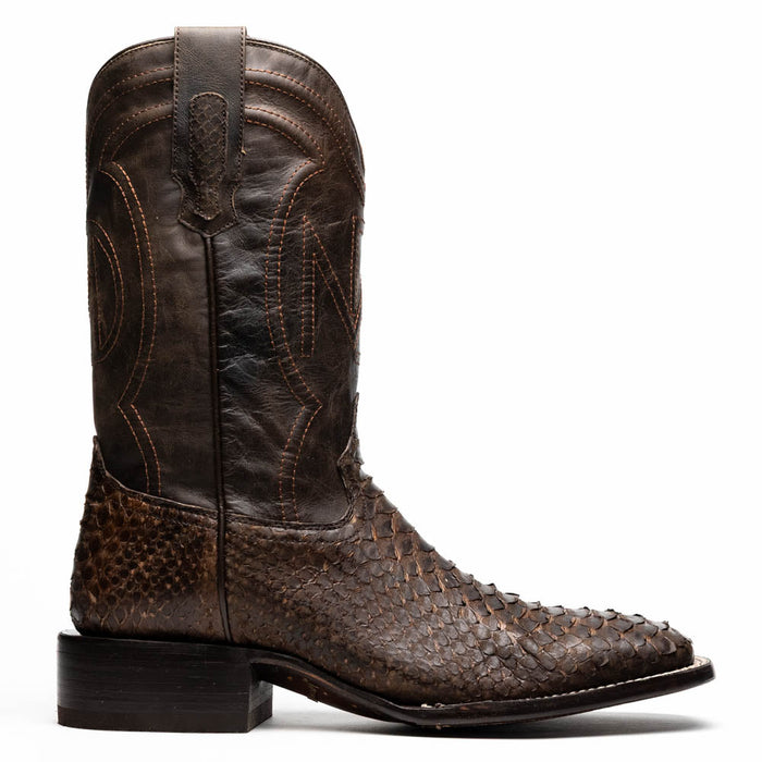 Brown python cowboy boots by Marco Di Milano. Tall shaft, square toe, and detailed stitching. Made with textured brown python skin. Raised heel and contrasting materials add structure and visual appeal.
