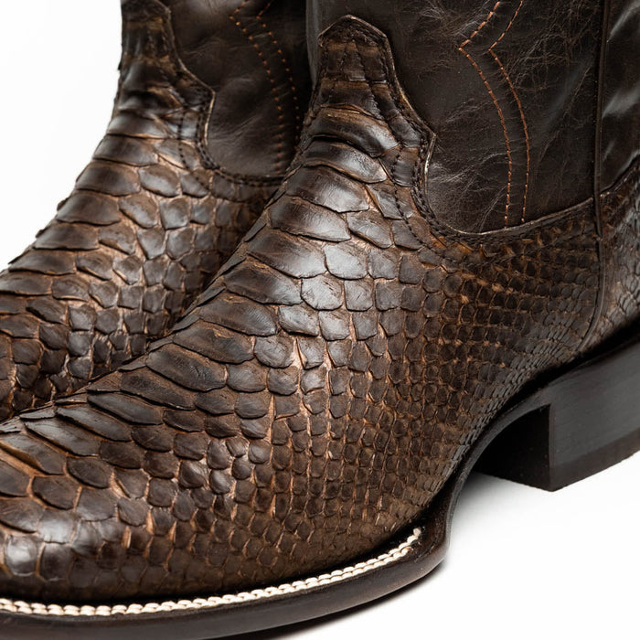 Marco Di Milano Missouri cowboy boots. Brown textured python skin upper, square toe, black leather heel. Brown stitched seams for detail. Smooth transition from skin to heel.
