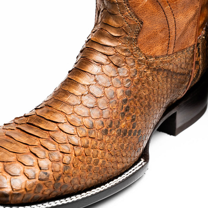 Marco Di Milano Missouri Cognac Python Cowboy Boots. Golden-brown python upper with square toe. Leather ankle, contrasting black outsole, and detailed stitching.
