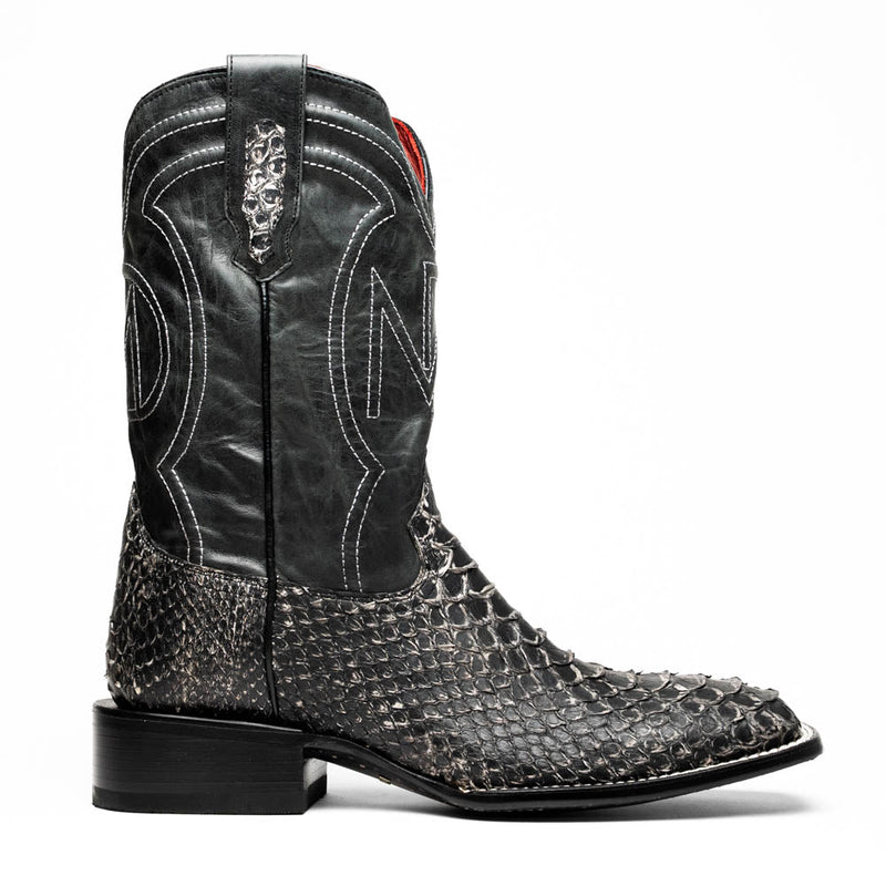 Marco Di Milano Missouri boots: Square toe, black leather upper with stitching, decorative pattern. Gray/white python skin lower, stacked heel. Structured, stylish cowboy design.
